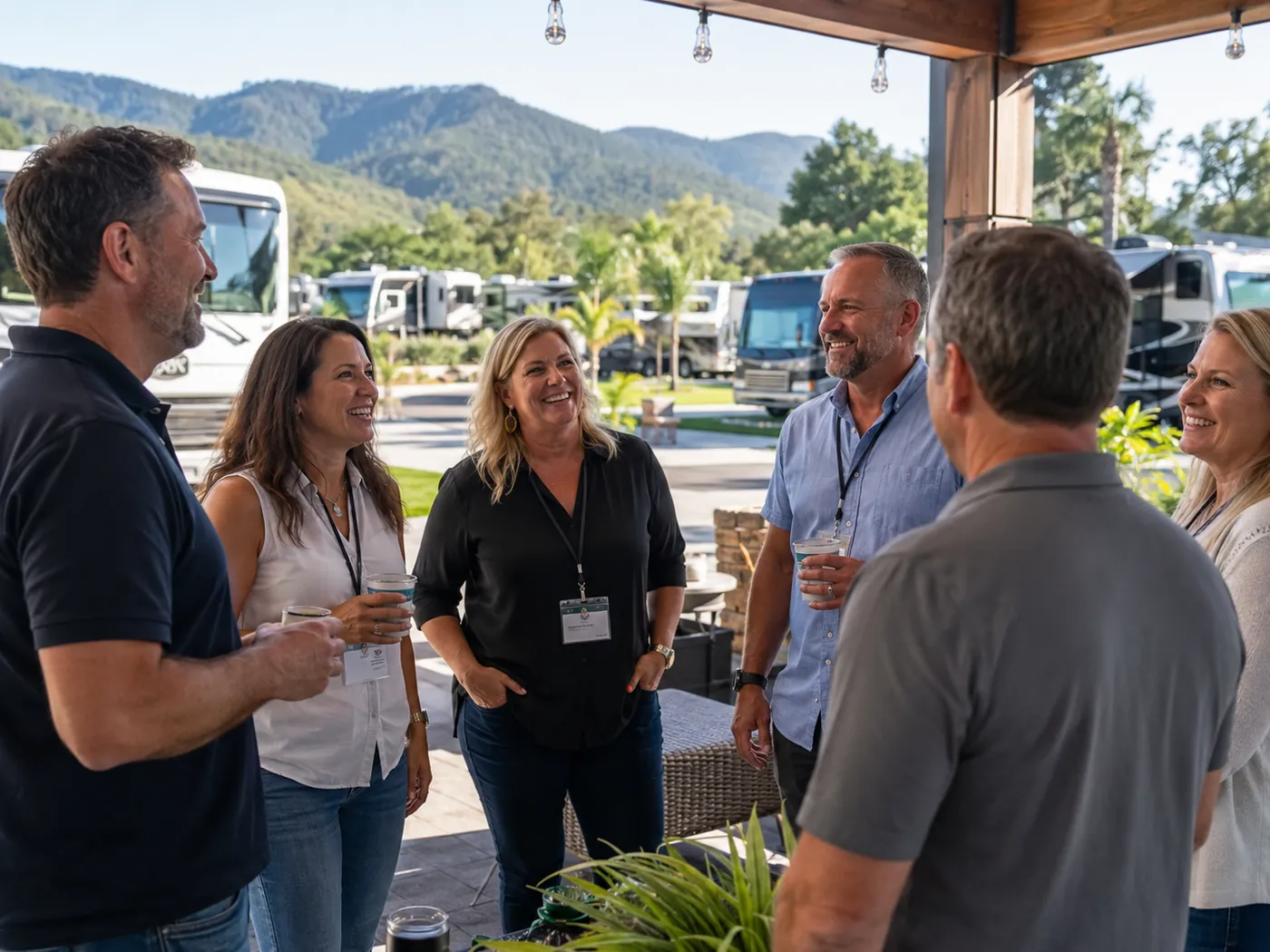 RV park owners gathering under a pavilion with parks and mountains beyond